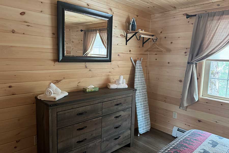 Dresser, Iron, And Ironing Board In The Cedar Suite Rental Cabin At The Pmr