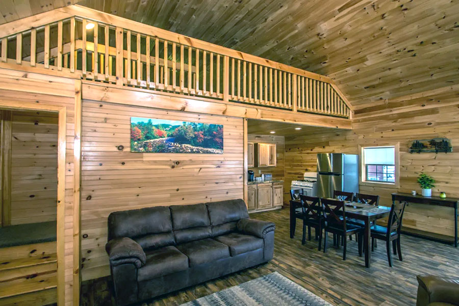 View Of Living Room And Upstairs Loft In The Oak Premier Rental Cabin At The Pmr