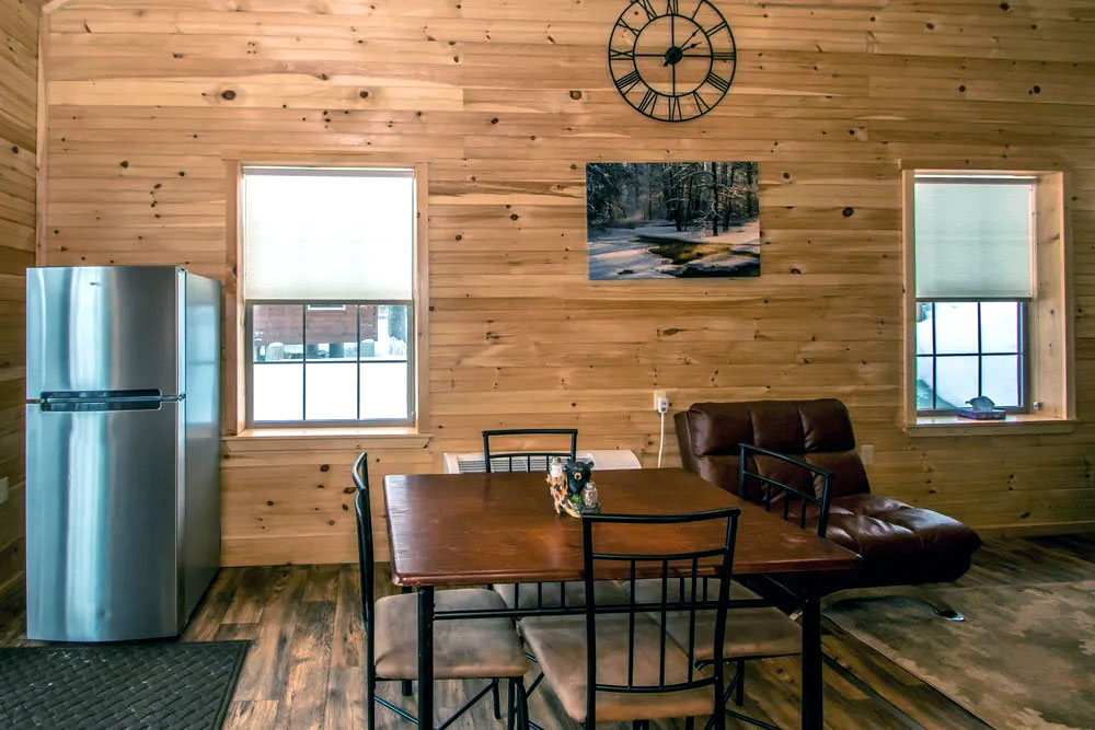 Photo To The Rental Cabin's Dinette Set, Lounge Chair And Refrigerator In The Rosewood Villa Cabin Rental